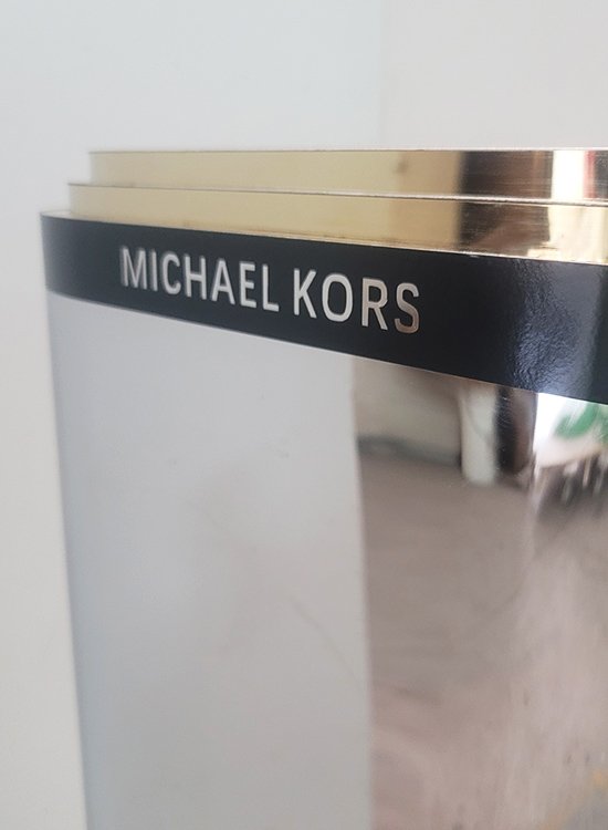 cutting MK logo on display stand for retail windows
