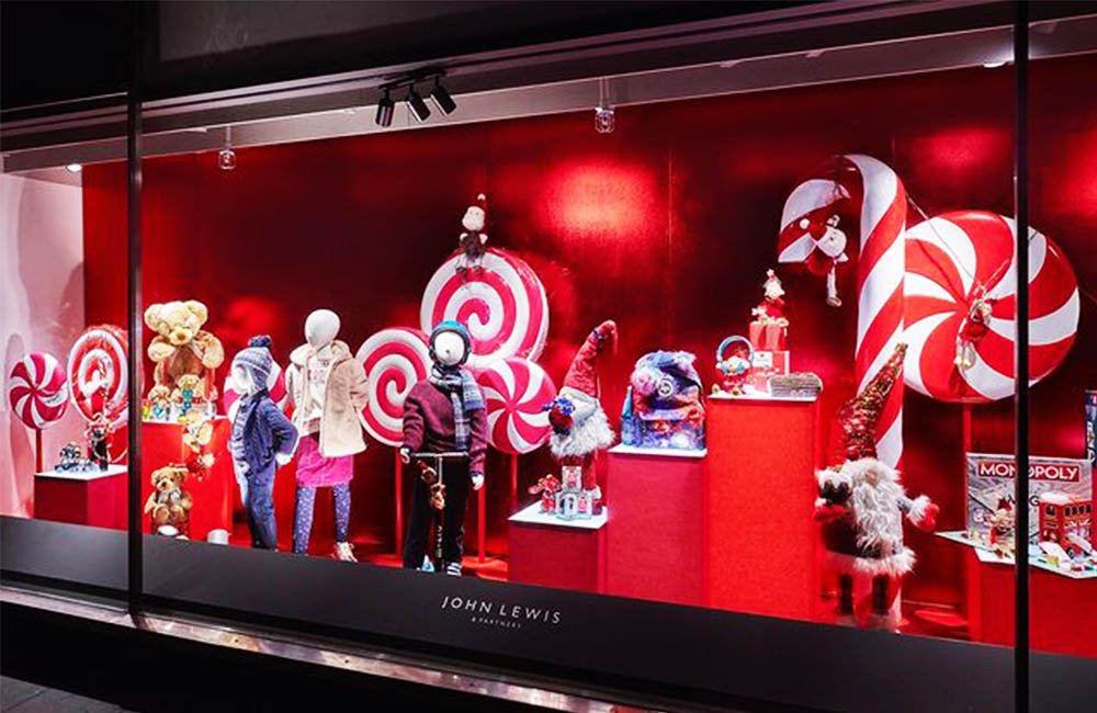 Christmas window display with candy canes and bells designs