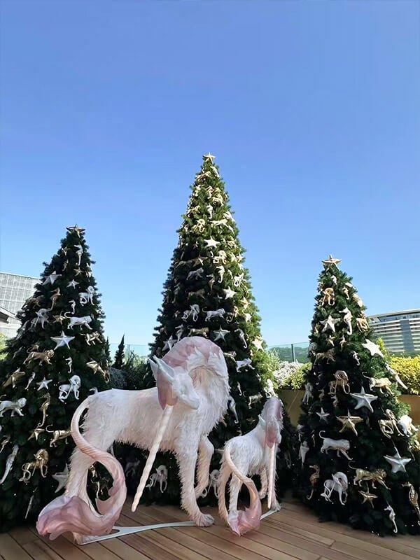 Dior outdoor display with paper crafts and Christmas tree ornaments