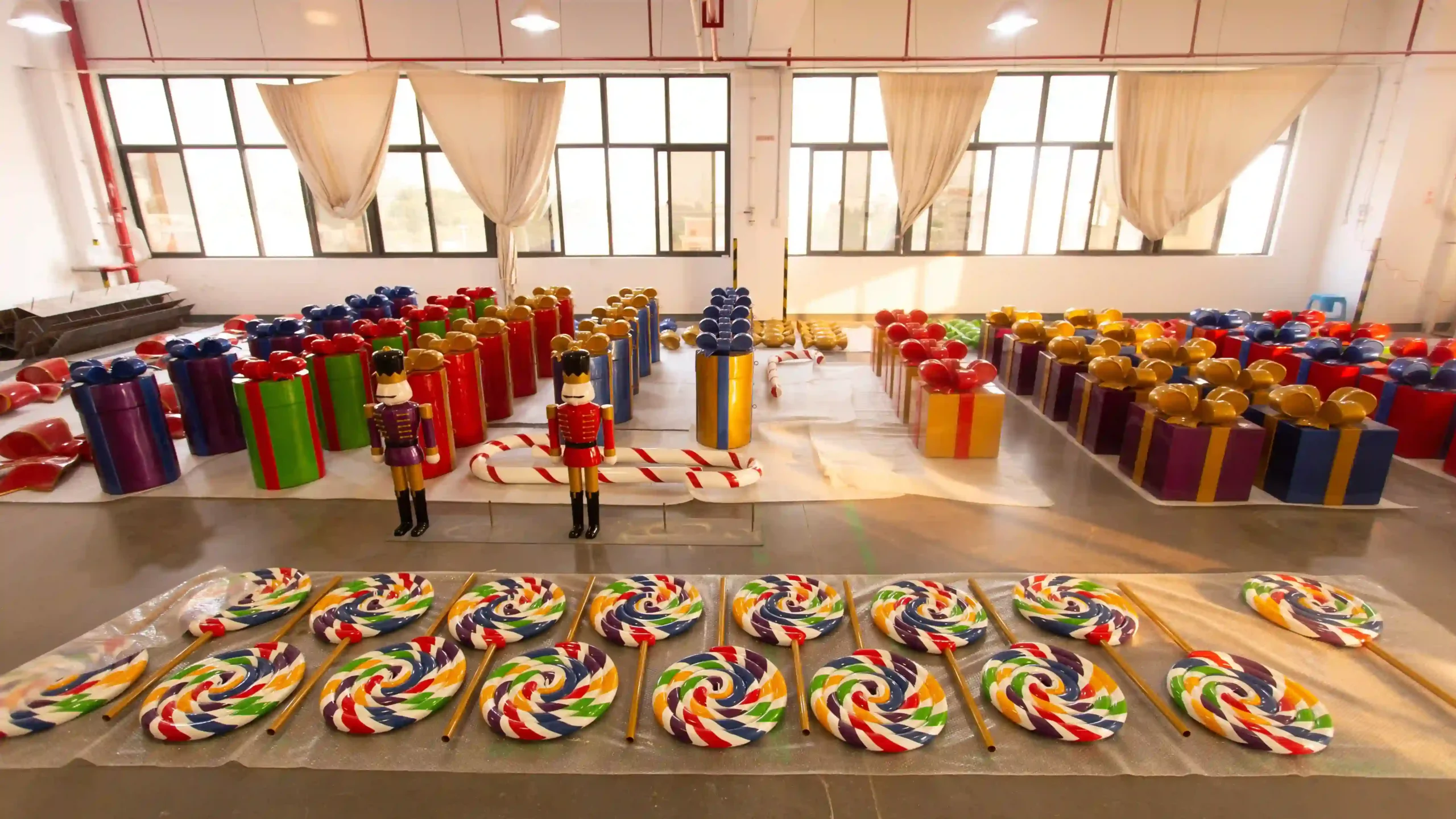 factory floor overview showing batch production of colourful oversized christmas display props